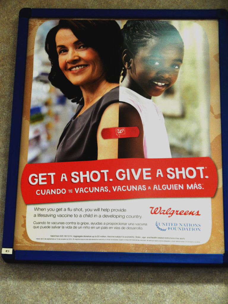 This sign is in the Walgreens pharmacy area that reminds people how they can Get a Shot. Give a Shot. 