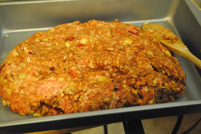 The meatloaf should be arranged so that it's somewhat flat and level so that it bakes at an even temperature. 