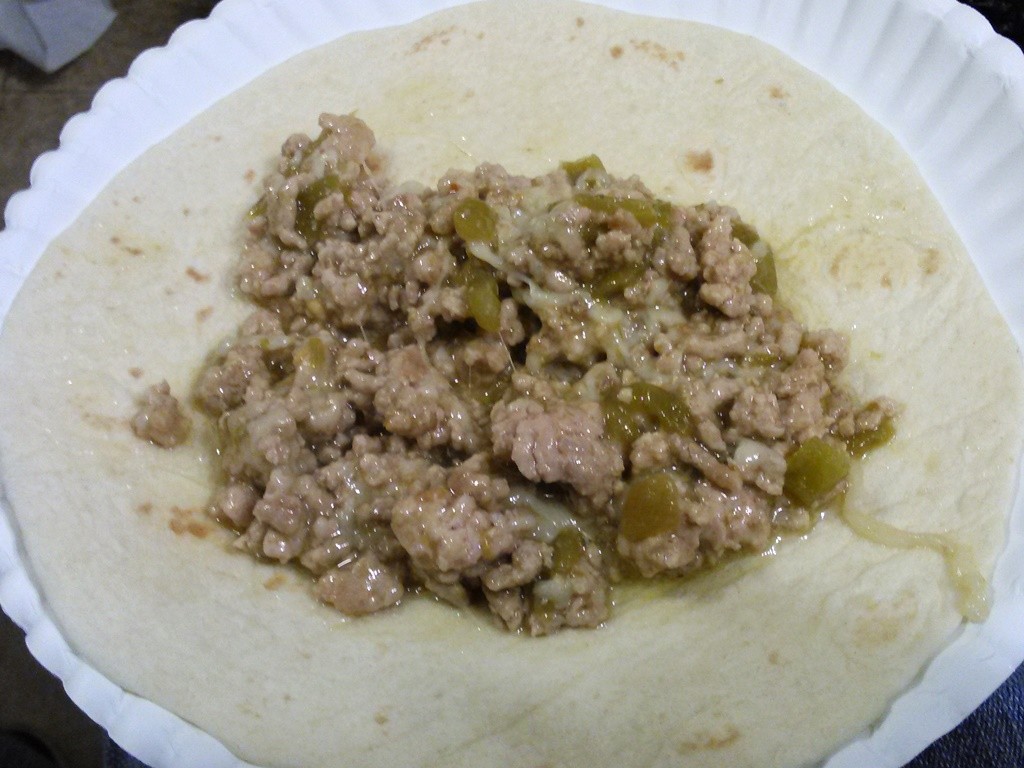 Place about a 1/2 cup of the meat/sauce mix in a tortilla. 