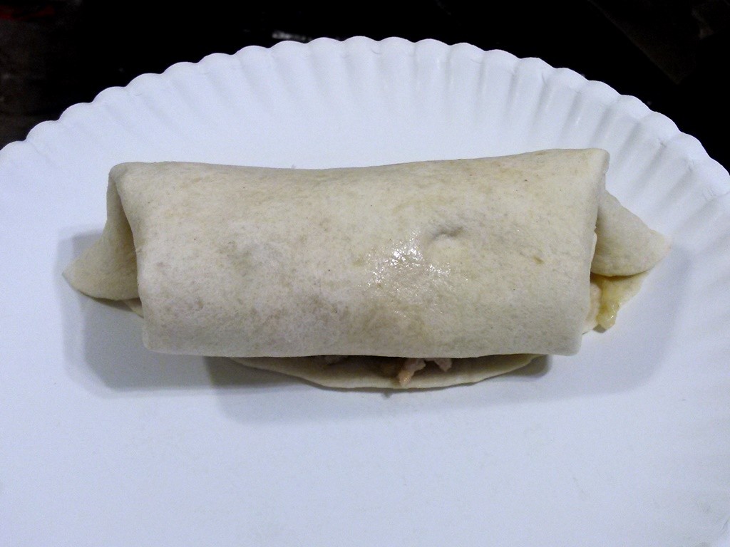 Roll the tortilla vertically from top to bottom, tucking in the edge into the tortilla. 