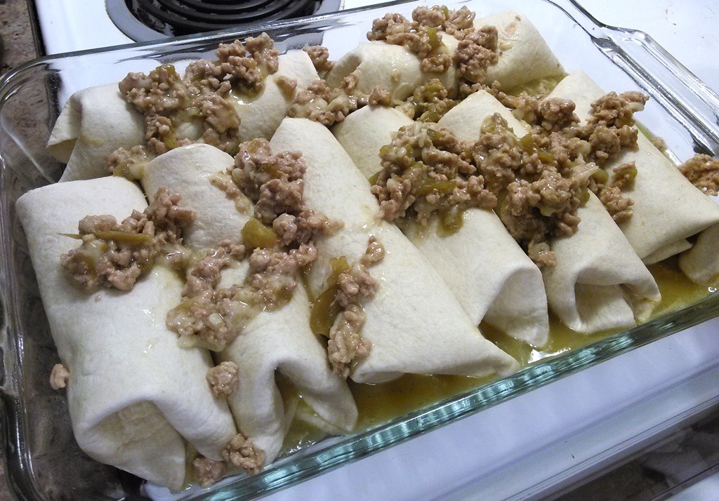 Sprinkle the remaining meat mix on top of the enchiladas. I try to make sure a little bit of meat is on each roll. 