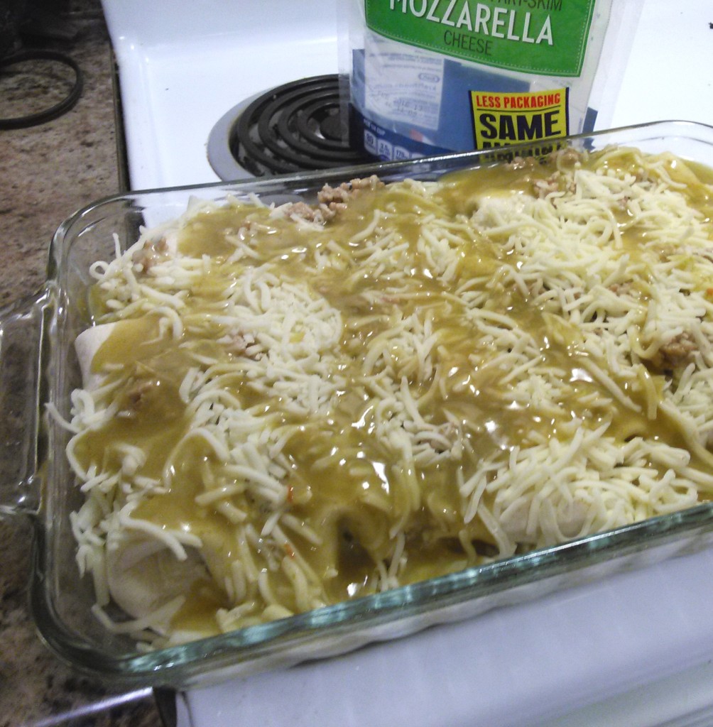 Drizzle the remaining 1/3 can of sauce over the enchiladas before baking. 
