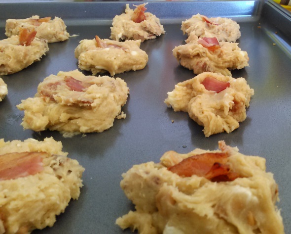 Gently press a small piece or two of bacon in the top of each cookie. 