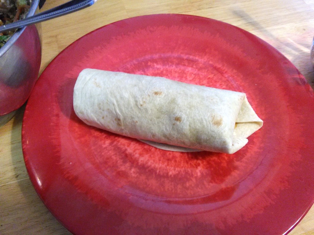 Roll up the tortilla to make an almost "burrito."