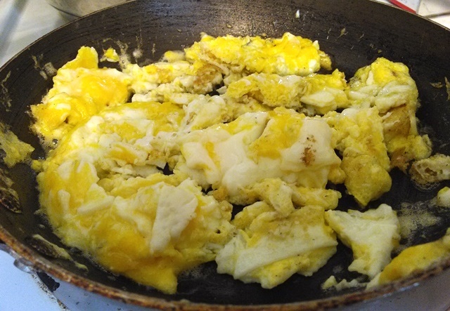 Scramble the eggs after the chicken. I normally cook the eggs in the same skillet as the chicken but I burned the garlic and it was ugly so this is a different skillet. 