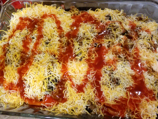 Drizzle the remaining 1/3 can of enchilada sauce over the entire casserole. 