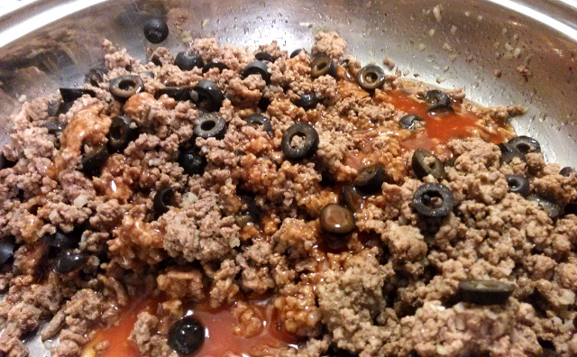 Add about 1/3 of your enchilada sauce to the meat mixture. 