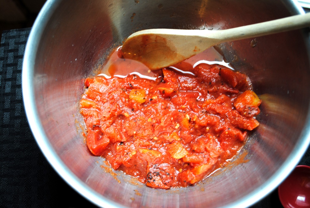 Open the can of fire roasted tomatoes and dump it in a bowl. 