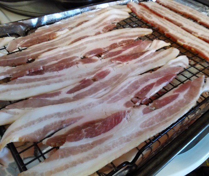 Lay the bacon out flat over the cooling rack and bake it. 10 minutes on one side and 10-15 more minutes on the other side (until crisp). 