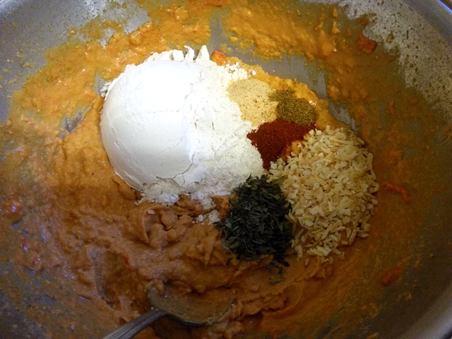 After blending the hummus, add the spices to your taste. The flour and baking soda tones down the spices that are already in the mix so all you're doing is enhancing what is already there. Wait to add the egg until you get the flavors to your liking to reduce the possibility of food poisoning. 